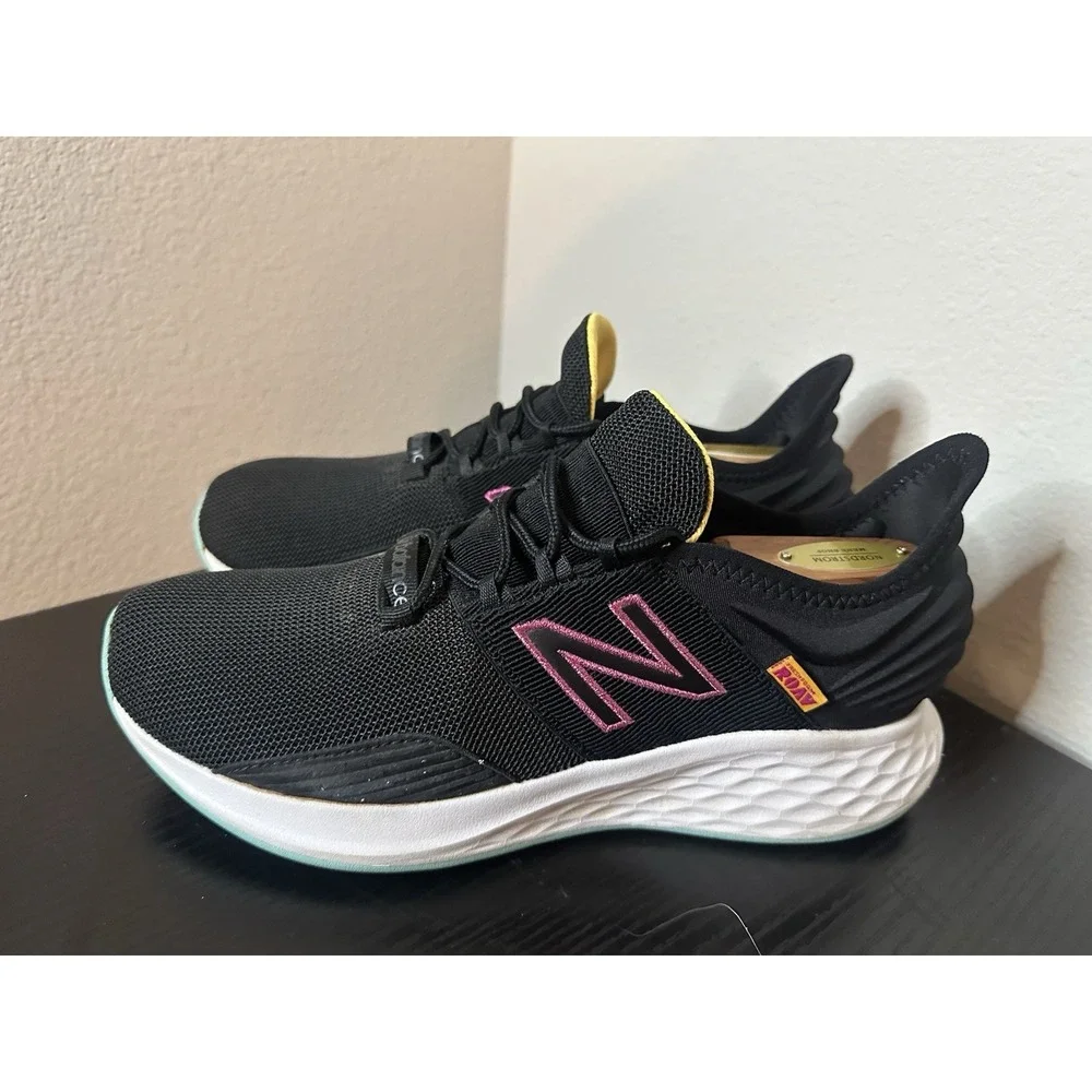 New Balance Black Athletic Sneakers with Pink and Yellow Accents
